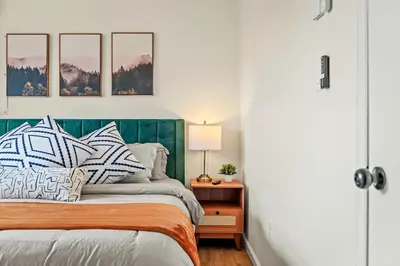 a bedroom with a bed with a green headboard at Cozy Pocono Retreat in Tobyhanna