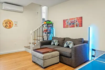 a living room with a couch and a stair case at Cozy Pocono Retreat in Tobyhanna