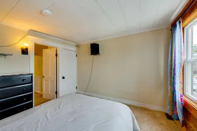 a bedroom with a bed and a dresser and a window at WFH Space and Yard! Walkable Lancaster Row Home in Lancaster