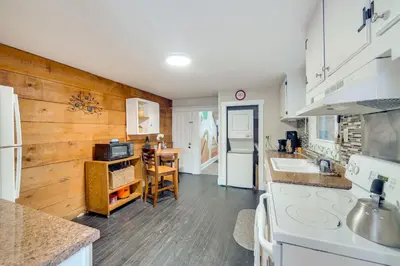 a kitchen with a wooden wall and a counter top at WFH Space and Yard! Walkable Lancaster Row Home in Lancaster