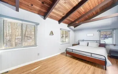 a bedroom with a bed and a wooden ceiling at Peaceful 4 Bedroom Home located near Lake in Hawley