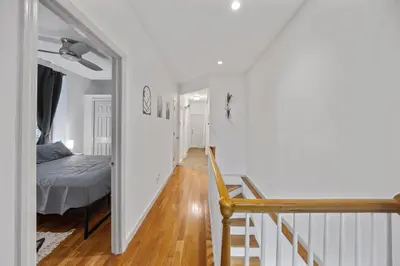 a hallway with a bedroom and a bed and a staircase at Suite Double Room with shared bathroom in Times Square in New York