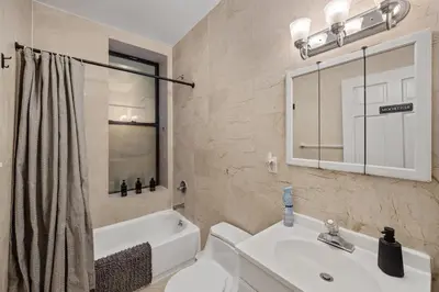 a bathroom with a sink and a toilet and a tub at Suite Double Room with shared bathroom in Times Square in New York