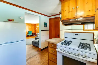 a kitchen with a white stove and a refrigerator at Year-Round Fun on Lake Sheridan! Home with Patio