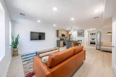 a living room with a couch and a kitchen at 2 Beds Sleeps 4 Near NYC and MetLife FIFA 2026 in Jersey City