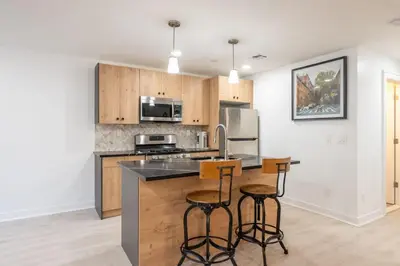 a kitchen with a counter and two bar stools at 2 Beds Sleeps 4 Near NYC and MetLife FIFA 2026 in Jersey City