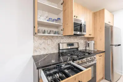 a kitchen with a stove and a refrigerator at 2 Beds Sleeps 4 Near NYC and MetLife FIFA 2026 in Jersey City