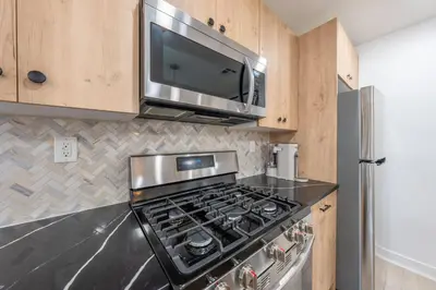 a kitchen with a stove and a microwave at 2 Beds Sleeps 4 Near NYC and MetLife FIFA 2026 in Jersey City