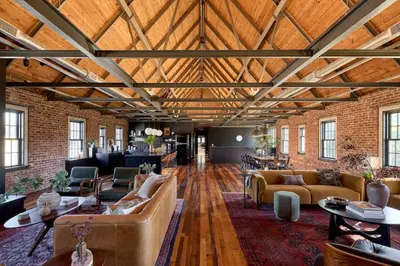 a large living room with couches and tables at Eleanor Inn - Suite Lorena in Warwick