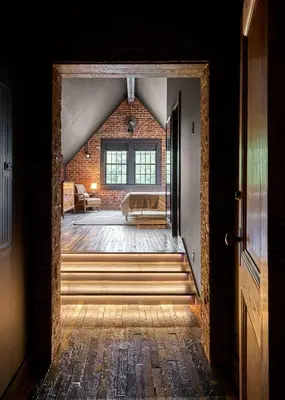 an open doorway to a room with a brick wall at Eleanor Inn - Suite Lorena in Warwick