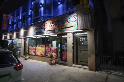 a building with neon signs on the side of it at Stylish & Comfortable City Stay in West New York