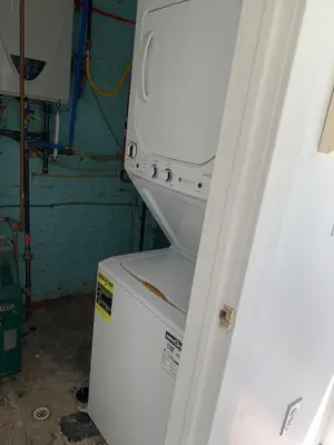 a white refrigerator with its door open in a room at 2 Bedroom Garden Apartment Near Journal Square - Prime World Cup Lodging in Jersey City
