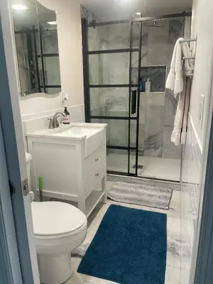 a bathroom with a toilet sink and a shower at 2 Bedroom Garden Apartment Near Journal Square - Prime World Cup Lodging in Jersey City