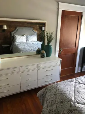 a bedroom with a bed with a large mirror at Comfortable Craftsman Getaway in Lancaster