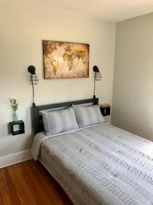 a bedroom with a bed with a map on the wall at Comfortable Craftsman Getaway in Lancaster