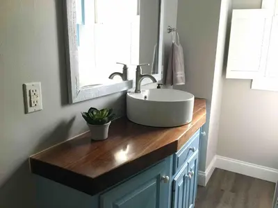 a bathroom with a sink and a mirror at Comfortable Craftsman Getaway in Lancaster