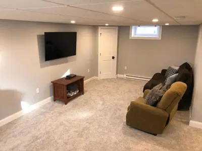 a living room with a couch and a television at Comfortable Craftsman Getaway in Lancaster