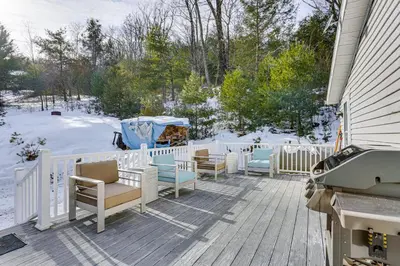 a porch with chairs and a fence in the snow at Hike and Explore! Nature-Centric Hudson Valley Home in Napanoch