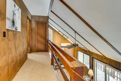 a staircase in a house with wooden walls at Poconos Retreat in The Hideout Lake Community! in Lake Ariel