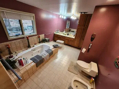 a bathroom with a tub and a toilet and a sink at Eagles Nest Mansion in Montgomery