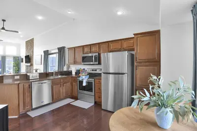 a kitchen with wooden cabinets and stainless steel appliances at Lux Camelback Summit: 5br, Hot Tub, Game Room in Tannersville