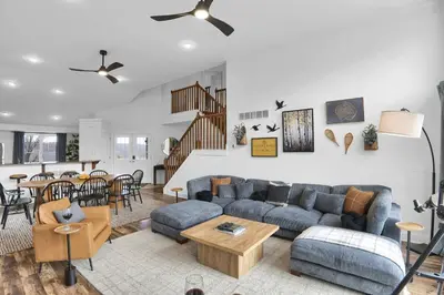 a living room with a couch and a table at Lux Camelback Summit: 5br, Hot Tub, Game Room in Tannersville