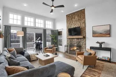 a living room with a couch and a fireplace at Lux Camelback Summit: 5br, Hot Tub, Game Room in Tannersville