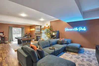 a living room with couches and a ping pong table at Lux Camelback Summit: 5br, Hot Tub, Game Room in Tannersville