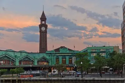 a large building with a clock tower on top of it at The Cozy Flat near the Apple in Jersey City