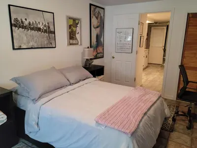 a bedroom with a bed with a pink blanket on it at The Cozy Flat near the Apple in Jersey City