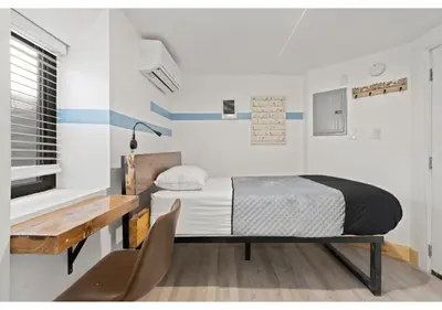 a small bedroom with a bed and a desk at Fairmount Park GSN Soil 2 in Philadelphia