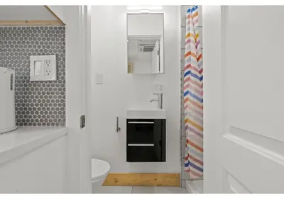 a white bathroom with a sink and a toilet at Fairmount Park GSN Soil 2 in Philadelphia