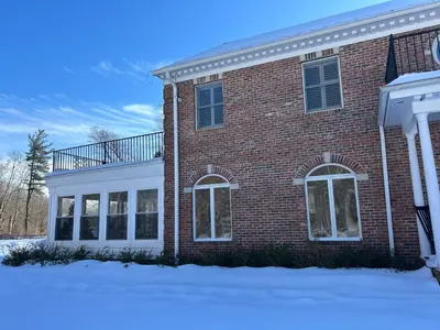 a brick house with a balcony on top of it at Luxury Private Estate, 5BR 6BA, close to MetLife with ample parking in Green Village