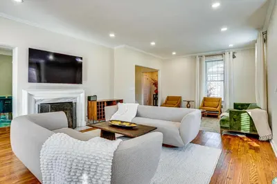 a living room with white furniture and a fireplace at Explore Orange and NYC! Luxury Family Home with Deck in Orange