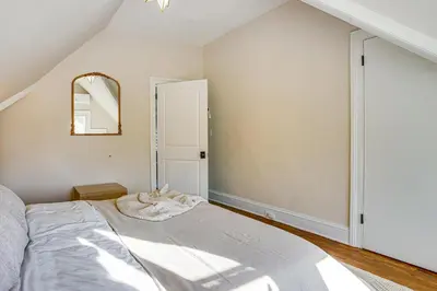 a bedroom with a bed and a mirror at Explore Orange and NYC! Luxury Family Home with Deck in Orange