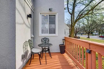 a patio with two chairs and a table on a balcony at Explore Orange and NYC! Luxury Family Home with Deck in Orange