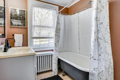 a bathroom with a tub and a sink at Explore Orange and NYC! Luxury Family Home with Deck in Orange