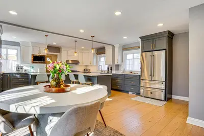 a kitchen with a table with flowers on it at Explore Orange and NYC! Luxury Family Home with Deck in Orange