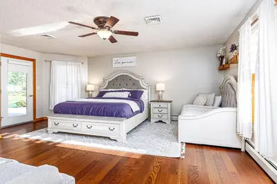 a bedroom with a bed and a ceiling fan at Blissful Mountain Getaway