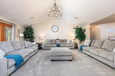a large living room with couches and a chandelier at Blissful Mountain Getaway