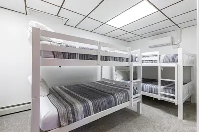 a bedroom with two bunk beds and a ceiling at Blissful Mountain Getaway