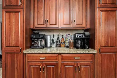 a kitchen with wooden cabinets and a counter top at Blissful Mountain Getaway
