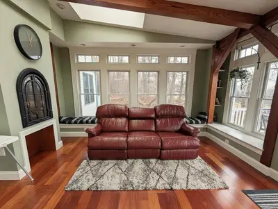 a living room with a brown leather couch at Fernwood Vista in Strasburg
