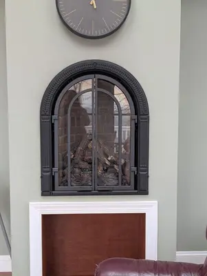 a clock on a wall above a fireplace at Fernwood Vista in Strasburg