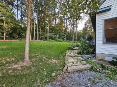 a yard with a tree and a house at Fernwood Vista in Strasburg