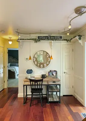 a dining room with a table and a clock on the wall at Fernwood Vista in Strasburg