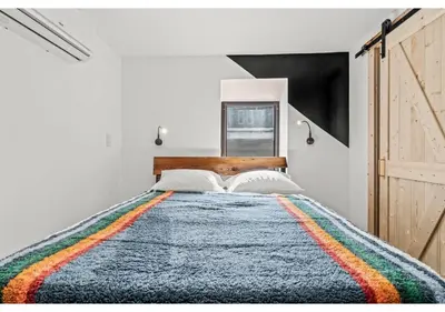 a bedroom with a large bed with a colorful blanket at Temple Town GSN Soil 3 in Philadelphia