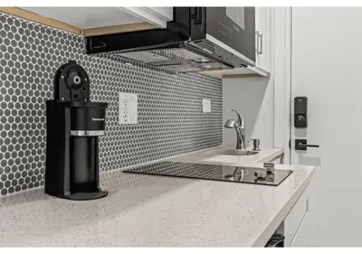 a kitchen with a sink and a coffee maker on a counter at Temple Town GSN Soil 3 in Philadelphia
