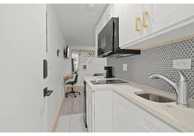a kitchen with a sink and a counter top at Temple Town GSN Soil 3 in Philadelphia