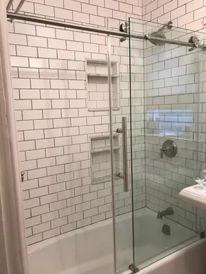 a bathroom with a shower with a glass door at Stylish Mission-Style Home on Park in Jersey City, NJ in Jersey City